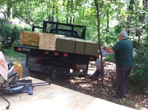 Just one of the multiple attempts to get the wood into position without it protruding into the driveway and without harming the dogwood tree. 
